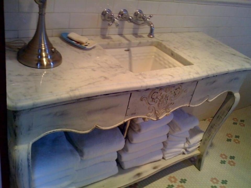 Old fashion bath room with claw foot tub, shower and vintage vanity