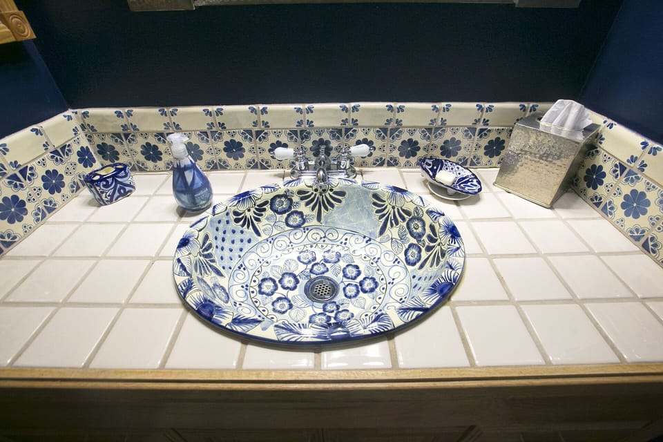 This stunning Mexican sink is centered on an Italian tile counter where there's plenty of room for your personal items. 