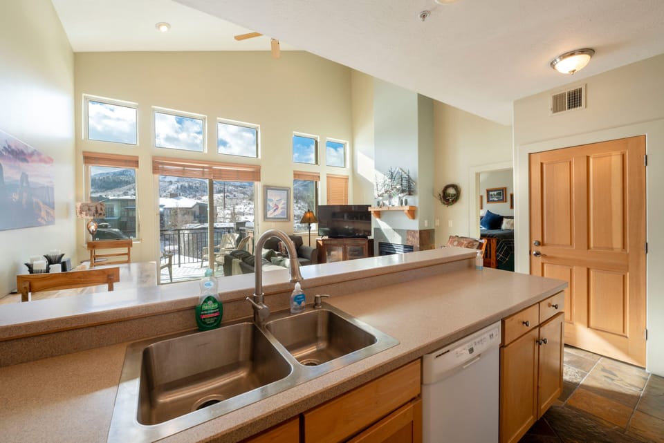 Large fully furnished kitchen with open view to living area and outside