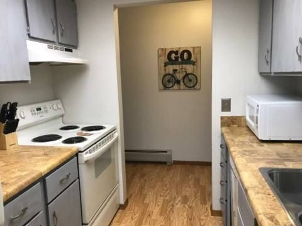 Kitchen w/appliances, cook/bakeware, place settings, microwave, and coffee machine