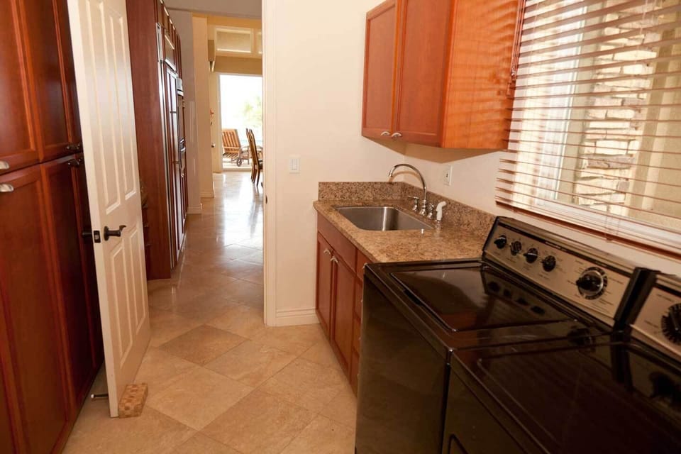 Laundry off kitchen offers additional storage for extra food our personal item