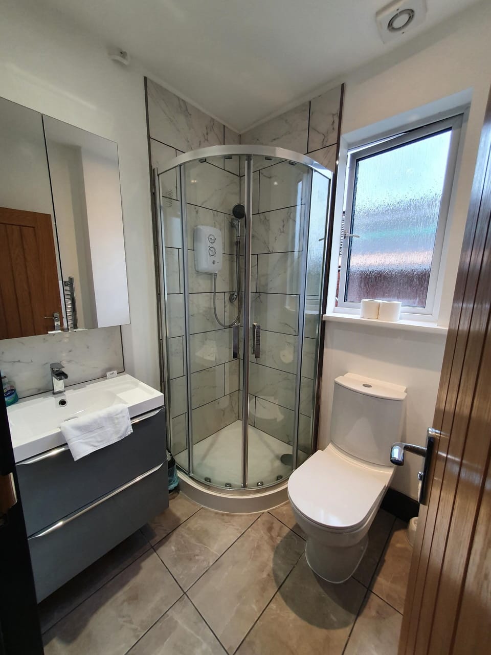 Deluxe Quad Studio | Bathroom | Shower, towels, toilet paper