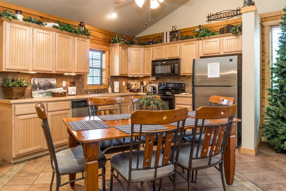 Full size kitchen with plenty of cabinets, counter space & table seating for six