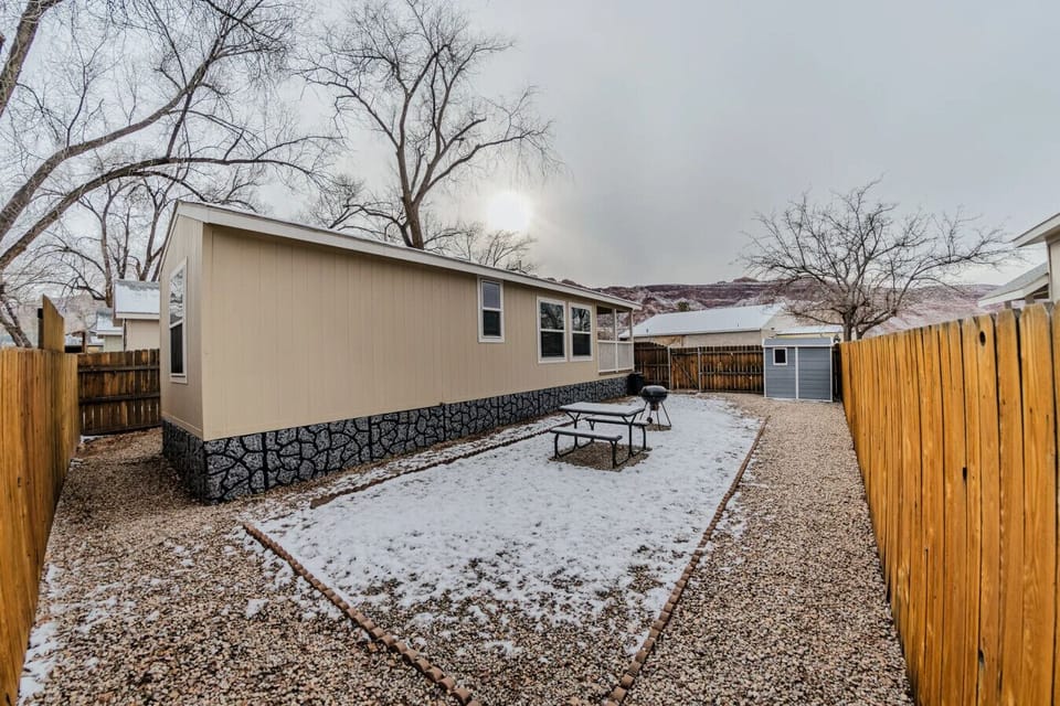 Spacious yard with picnic table and charcoal grill
