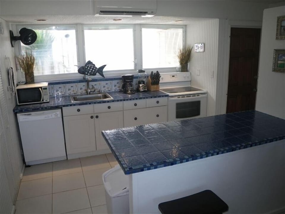 Newly updated caribbean kitchen and mahogany doors.