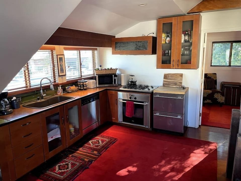 Kitchen, with filtered water, a dishwasher, microwave, toaster, kettle, 2-drawer fridge, oven, and coffee maker.