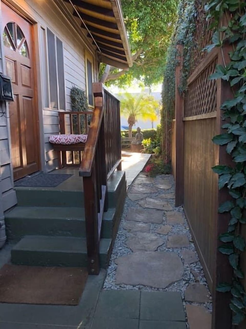 Path to Baby Dux after entering the right hand gate of the parking lot. Walk past the Buddha to the porch facing Anacapa Street.
