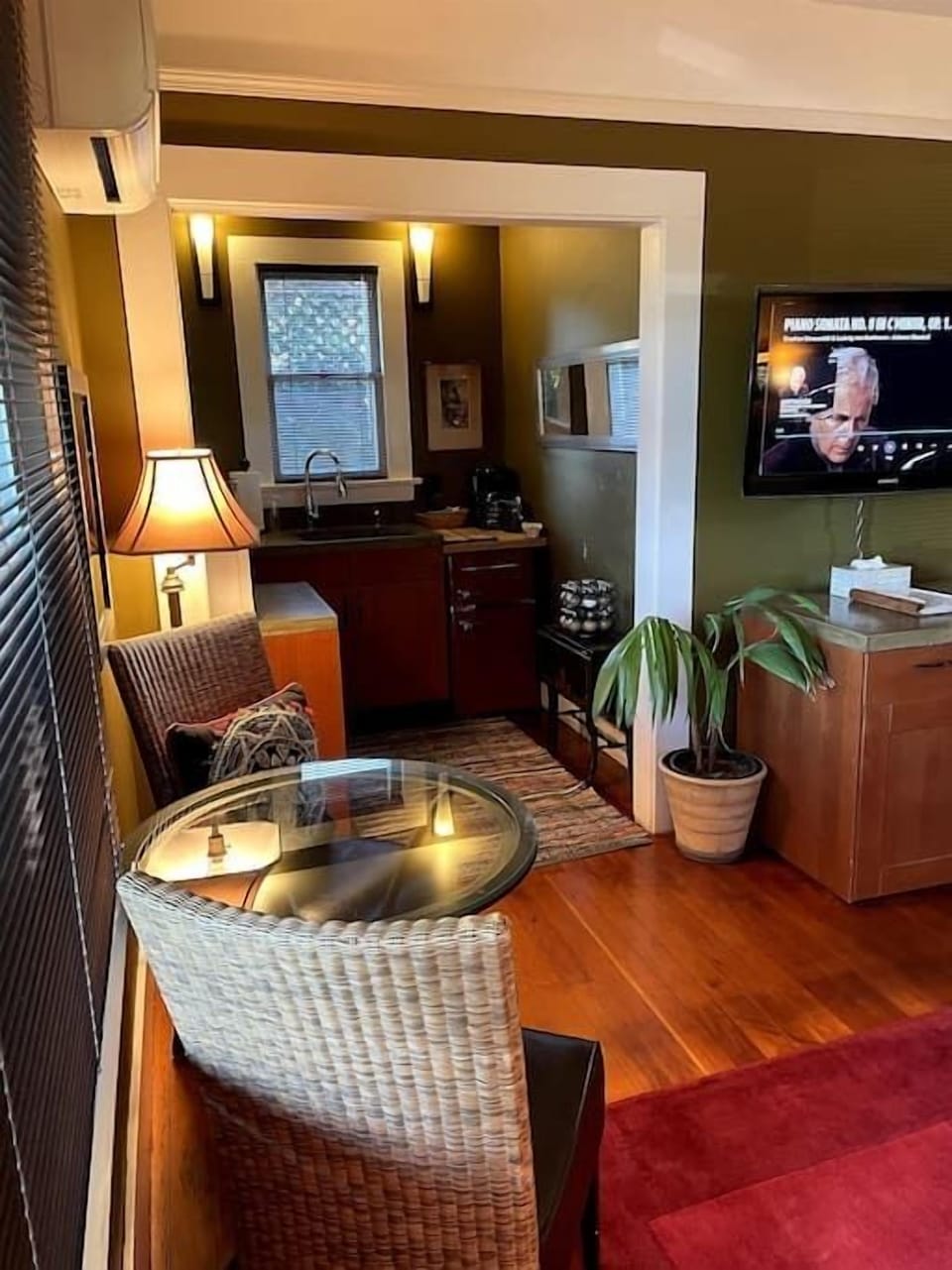 Seating for two facing the TV and kitchenette.