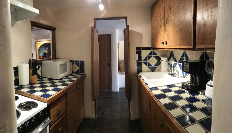 View of kitchen, with bar-style hand made doors.
