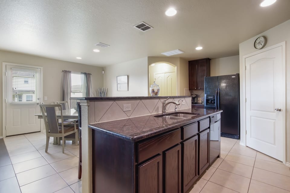 Hard surface counter tops including, dishwasher and full size fridge.