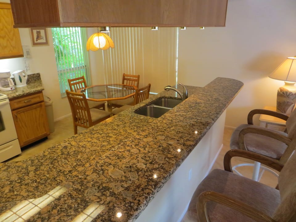 Our kitchen has a breakfast area and breakfast bar with swivel bar stools
