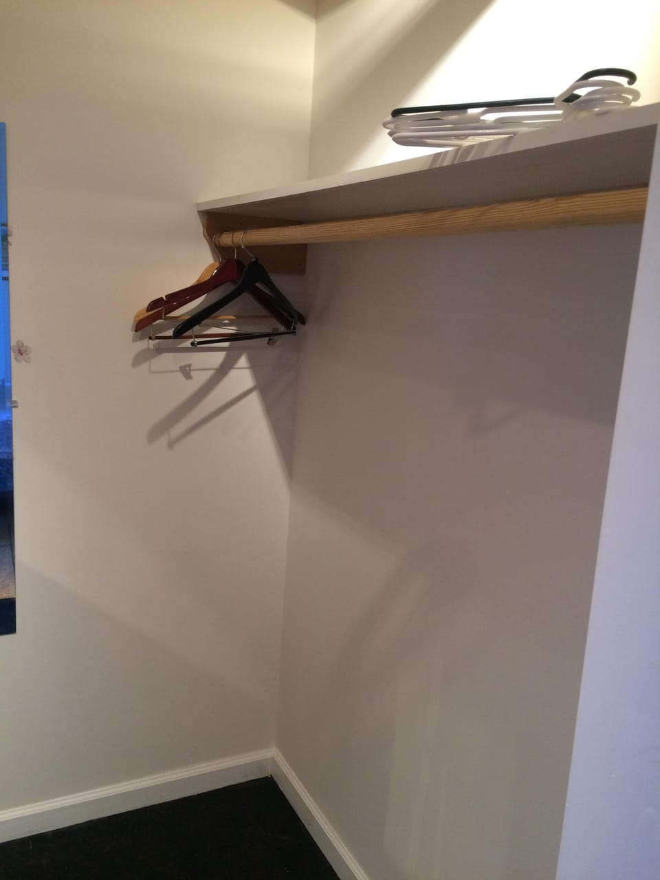 Lots of space for hanging garments and storage shelf in walk-in closet