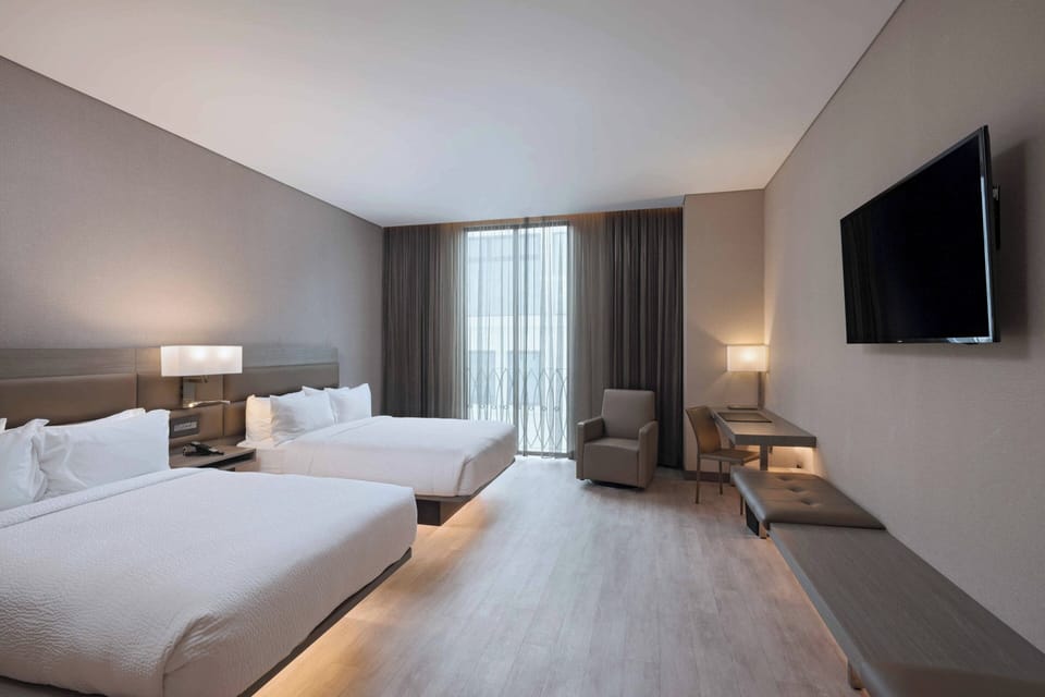 Deluxe Room, 2 Double Beds, Balcony | In-room safe, desk, blackout drapes, soundproofing