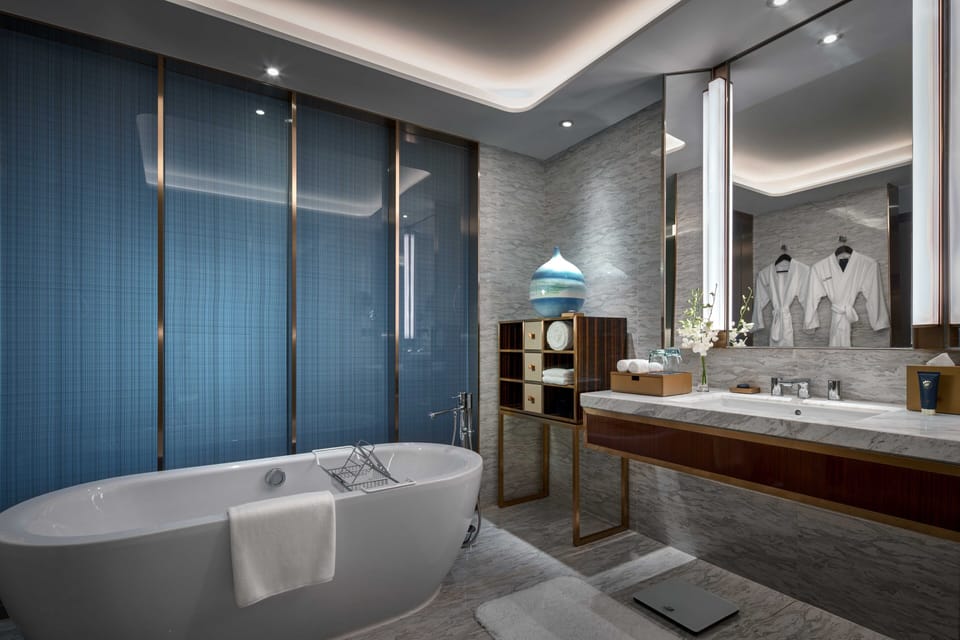 Separate tub and shower, designer toiletries, hair dryer, bathrobes