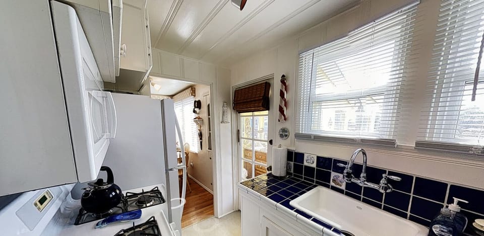 Kitchen sink with a view of the Deck, Garden and Harbor-Door to back porch