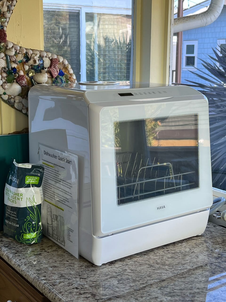 Small capacity dishwasher uses only 1.5 gallons water. Located on back porch