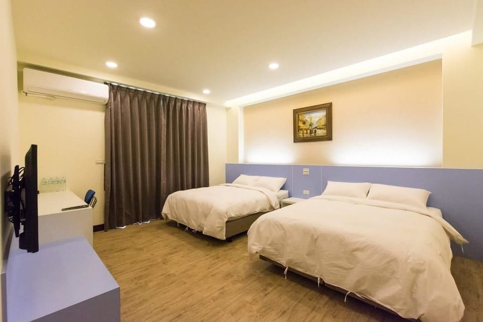 Deluxe Quadruple Room | Down comforters, desk, blackout drapes, free WiFi