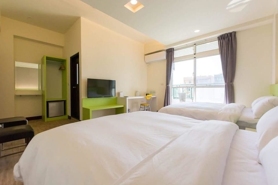 Deluxe Quadruple Room | Down comforters, desk, blackout drapes, free WiFi
