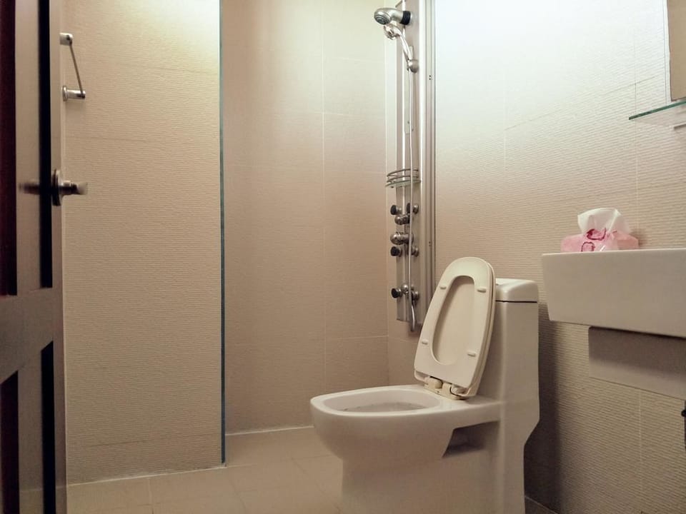 Family Room, 2 Double Beds | Bathroom | Shower, free toiletries, hair dryer, slippers