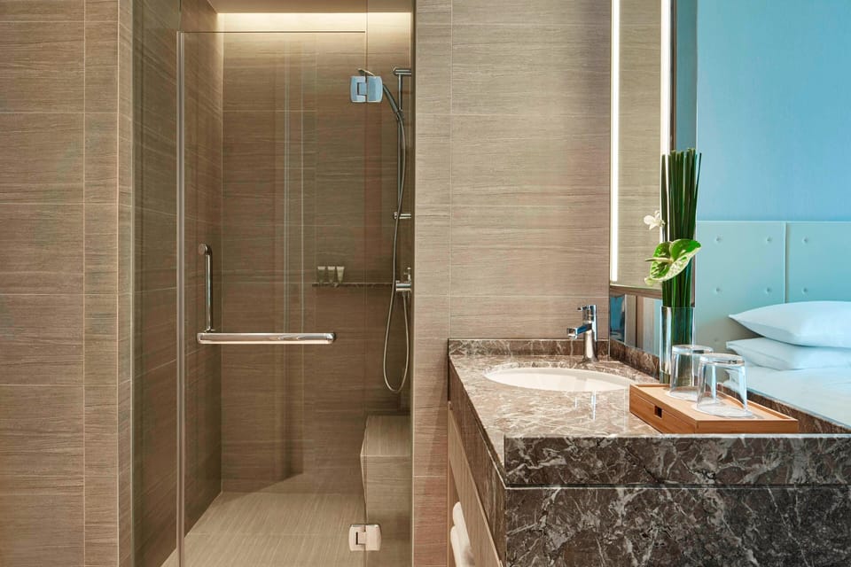 Shower, designer toiletries, hair dryer, bathrobes