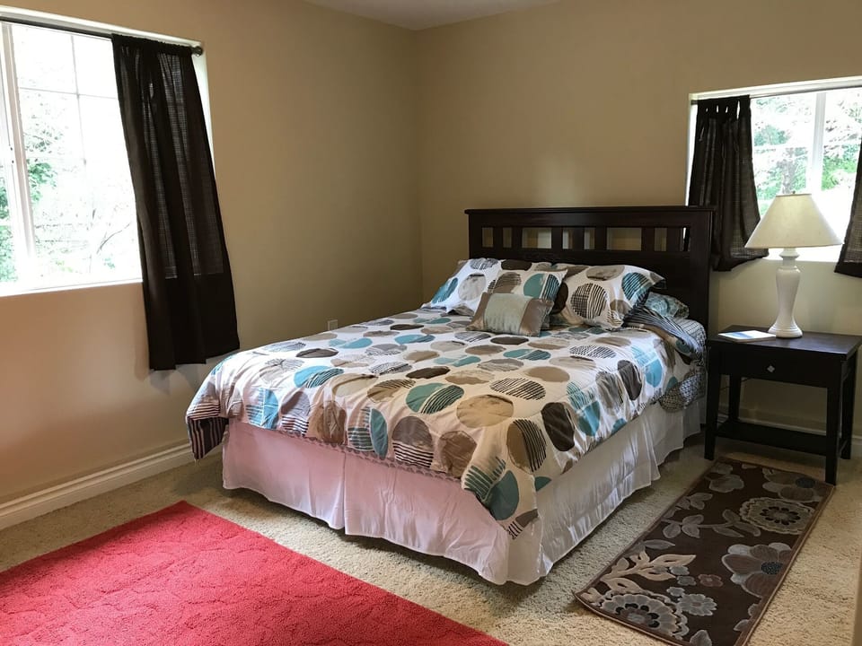 Forest-view bedroom with queen bed