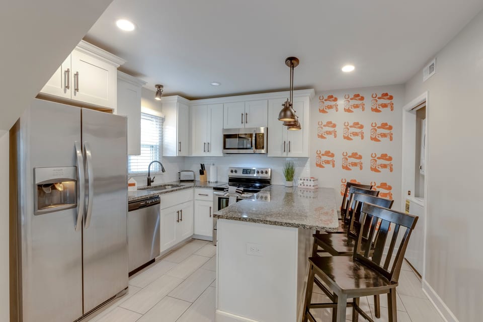 Fully equipped kitchen with granite countertops and modern appliances