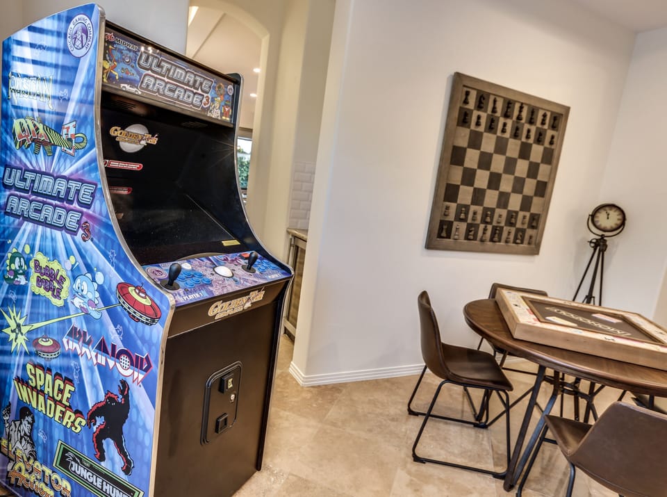 Fun game room with shuffle board, game table, arcade games, monopoly, chess and poker!