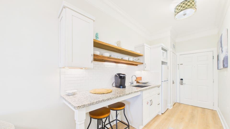 Kitchenette with barstool seating and coffee essentials