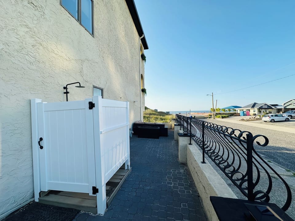 Enclosed outdoor shower on gated oceanfront patio