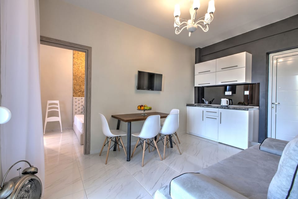 Suite, 2 Bedrooms | Living area | 30-inch LCD TV with satellite channels, TV