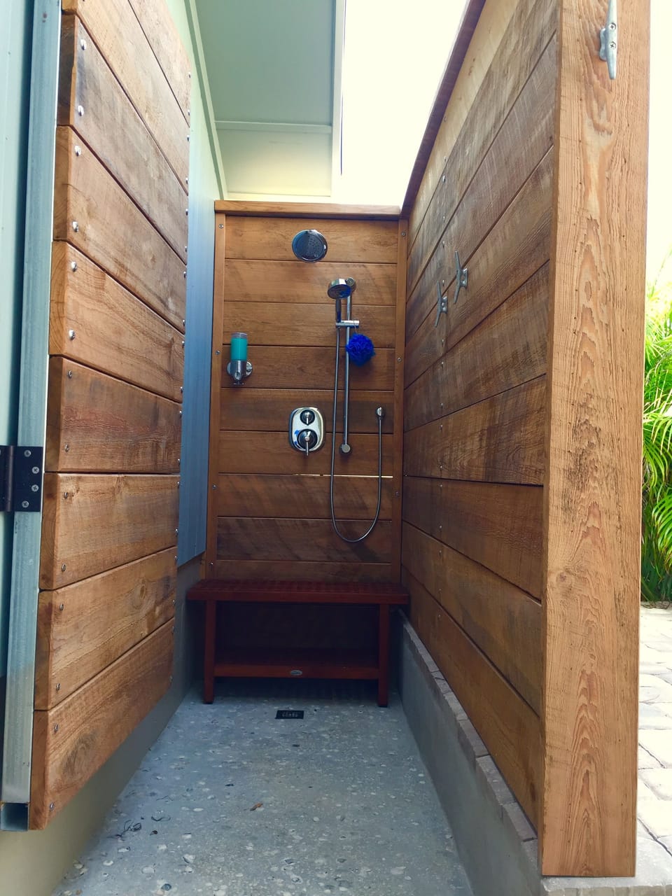 Outdoor shower with hot/cold water, soap dispenser, and privacy door