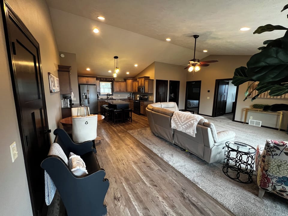 Living room view. Built-in desk area. Dining table and chairs bar seating for 5