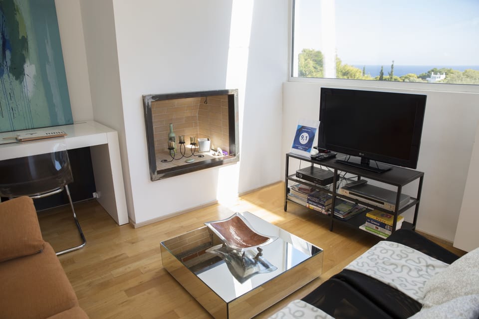 Deluxe Apartment, Partial Sea View | Living room | Flat-screen TV