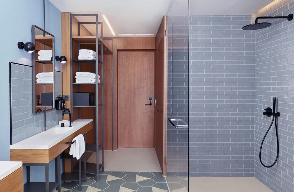 Shower, designer toiletries, hair dryer, towels