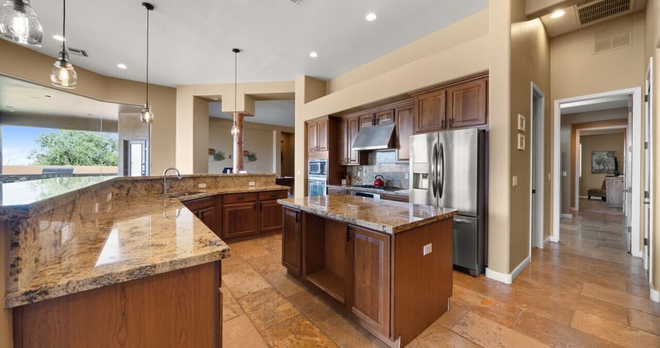 [Kitchen] Fully equipped kitchen with 5-burner gas stove, double ovens, and lots of prep space