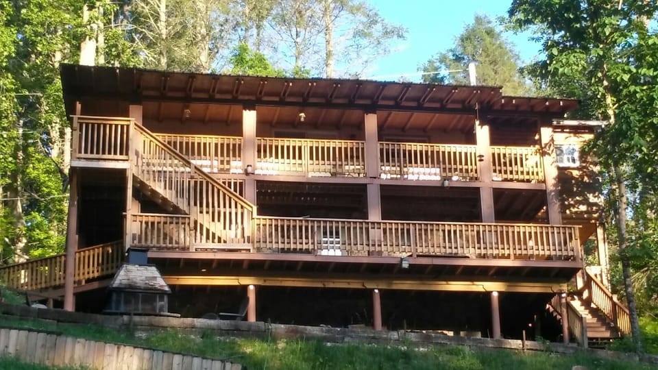 Back yard of the house 2 covered decks and Fire pit overlooking the cove.