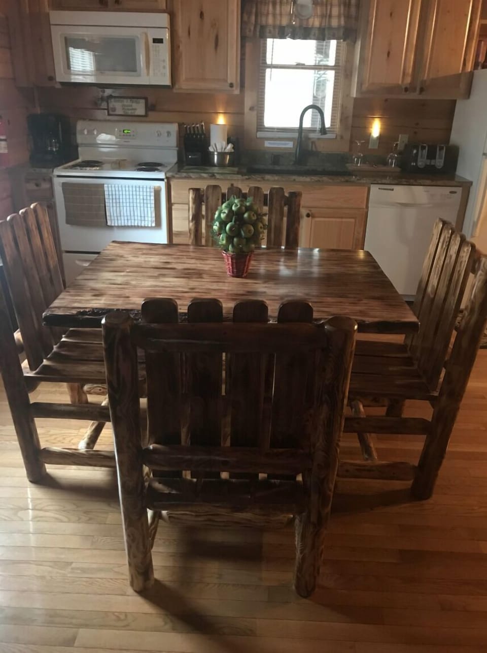 Kitchen with rustic table and granite countertops. 