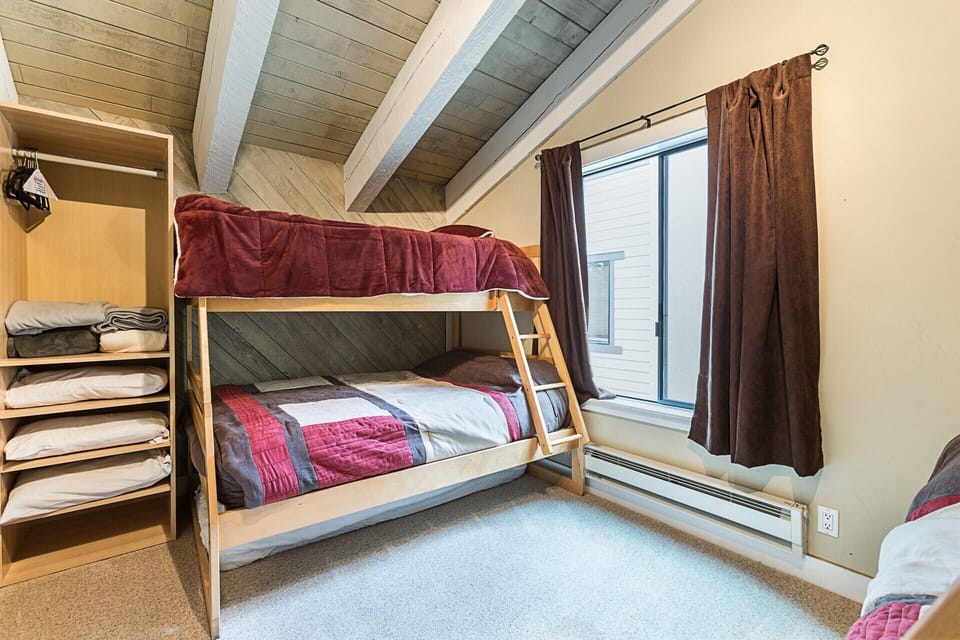 View of one side of the loft bedroom, both bunks have singles underneath as well