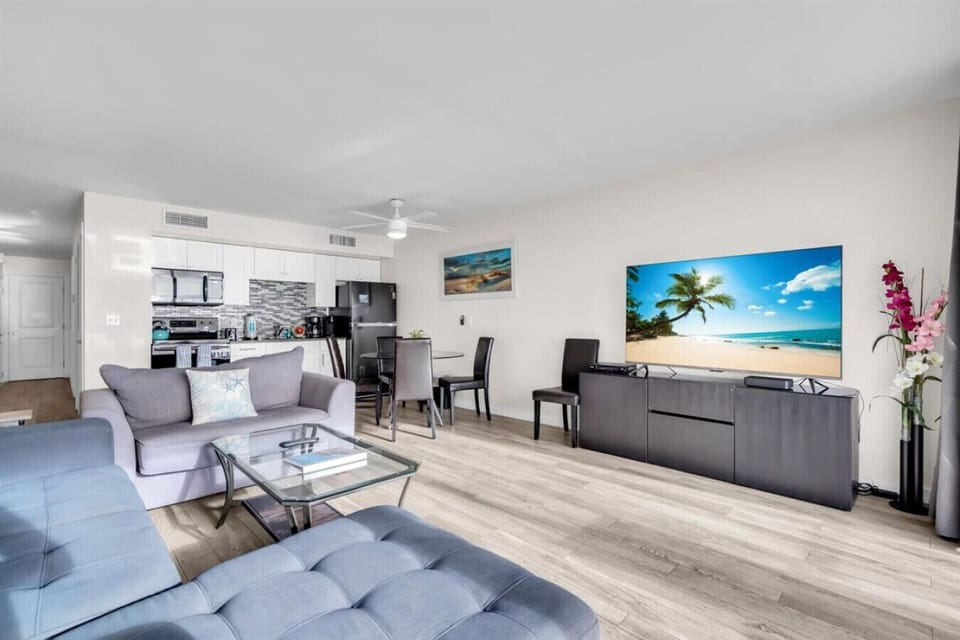 Light-filled living room with cozy seating and a calm, coastal vibe.