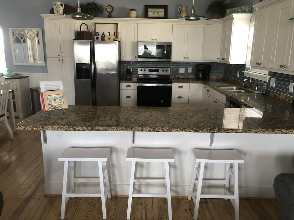 Large granite bar to gather for family game nights or lounging with friends.