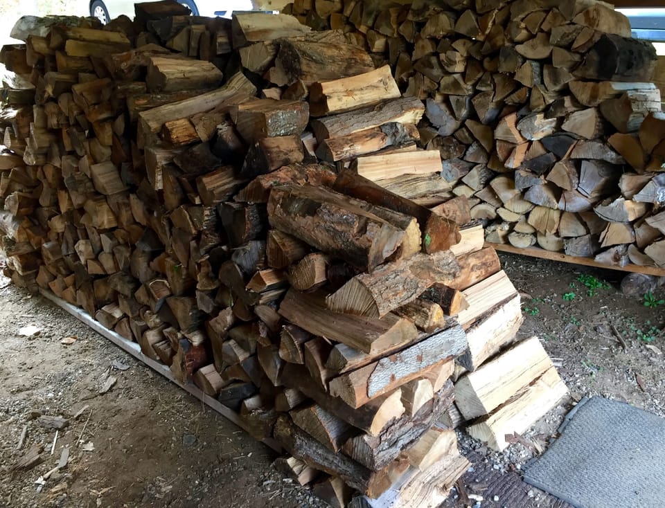 A large supply of firewood in wood shed.