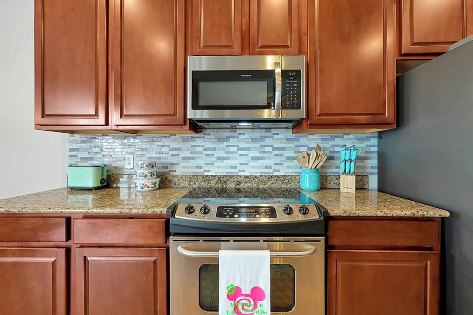 The high end, fully equipped kitchen features granite counter tops, stainless appliances and granite counter tops..
