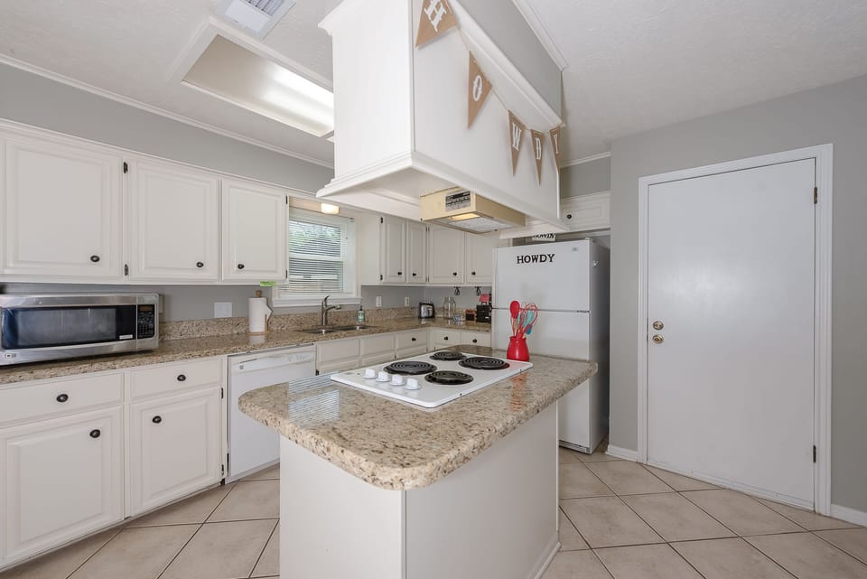 Spacious kitchen has granite counters,  2 coffee makers, and lots of appliances.