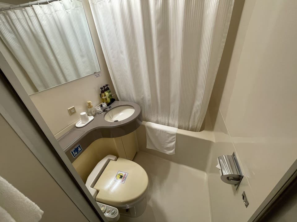 Combined shower/tub, free toiletries, hair dryer, slippers