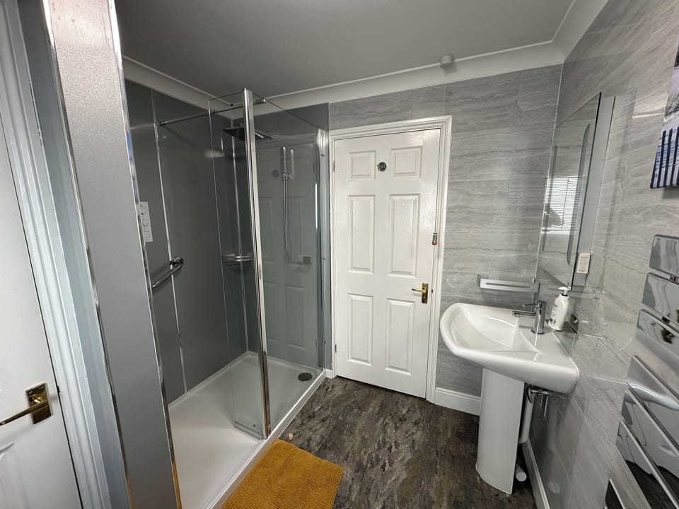 Large walk in shower with overhead and hand held shower heads