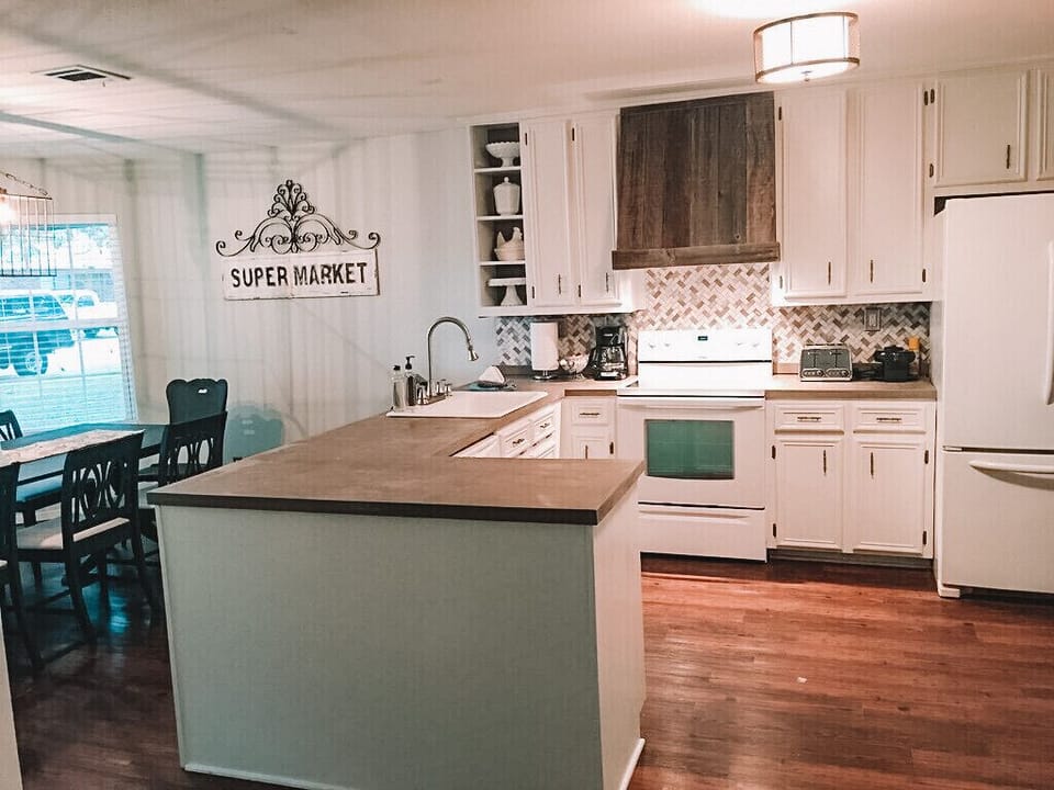 Kitchen stocked w/ a variety of utensils, pots/pans, dishes, and lots of extras