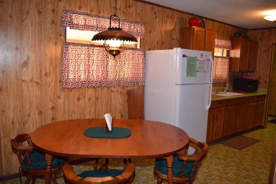 Kitchen table seats 4-6 (leaf and 2 folding chairs available).