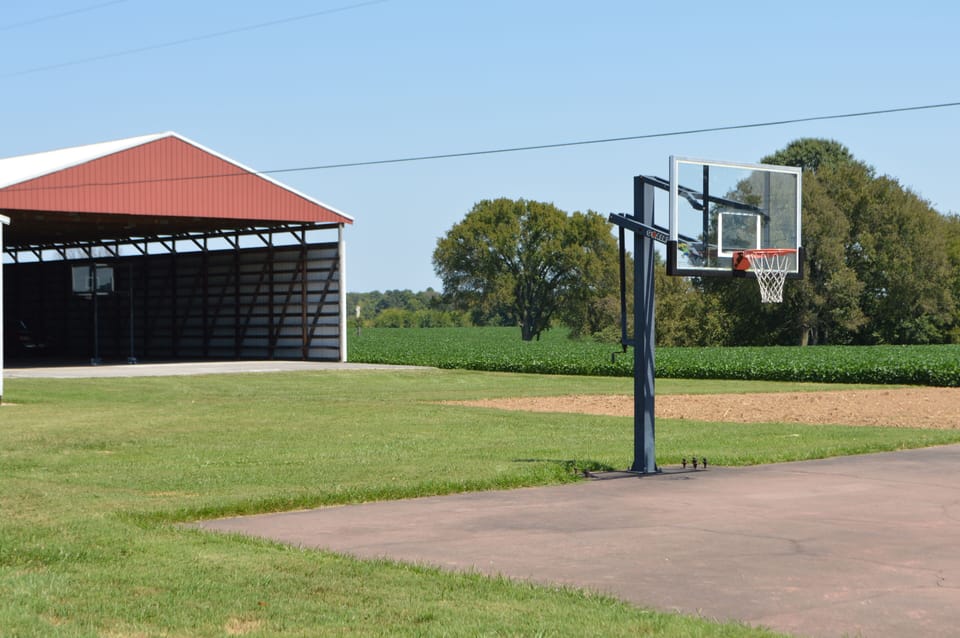 Full size basketball court in background; smaller goal in foreground
