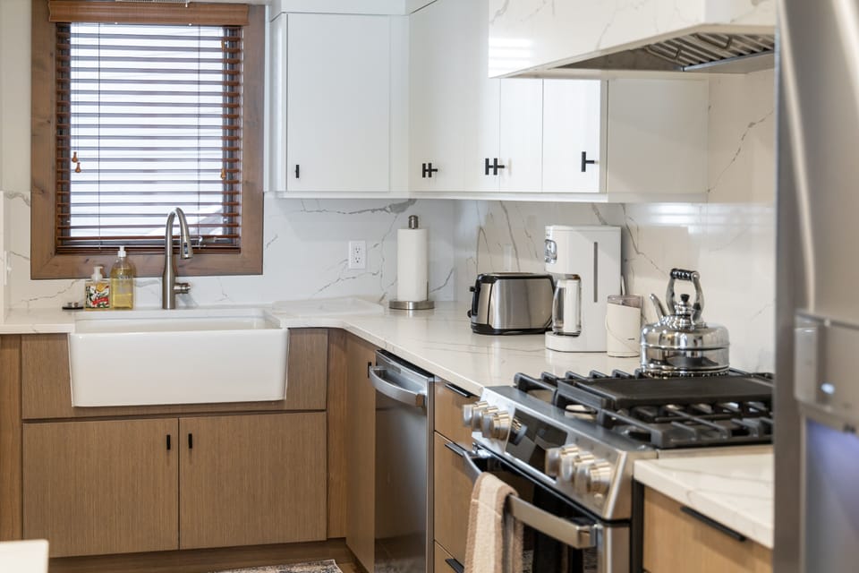 Farm sink and disposal, dishwasher, coffee maker and toaster. Great counters.