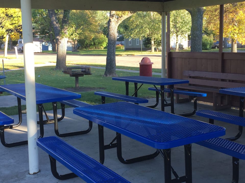 Park with charcoal grill and covered picnic tables